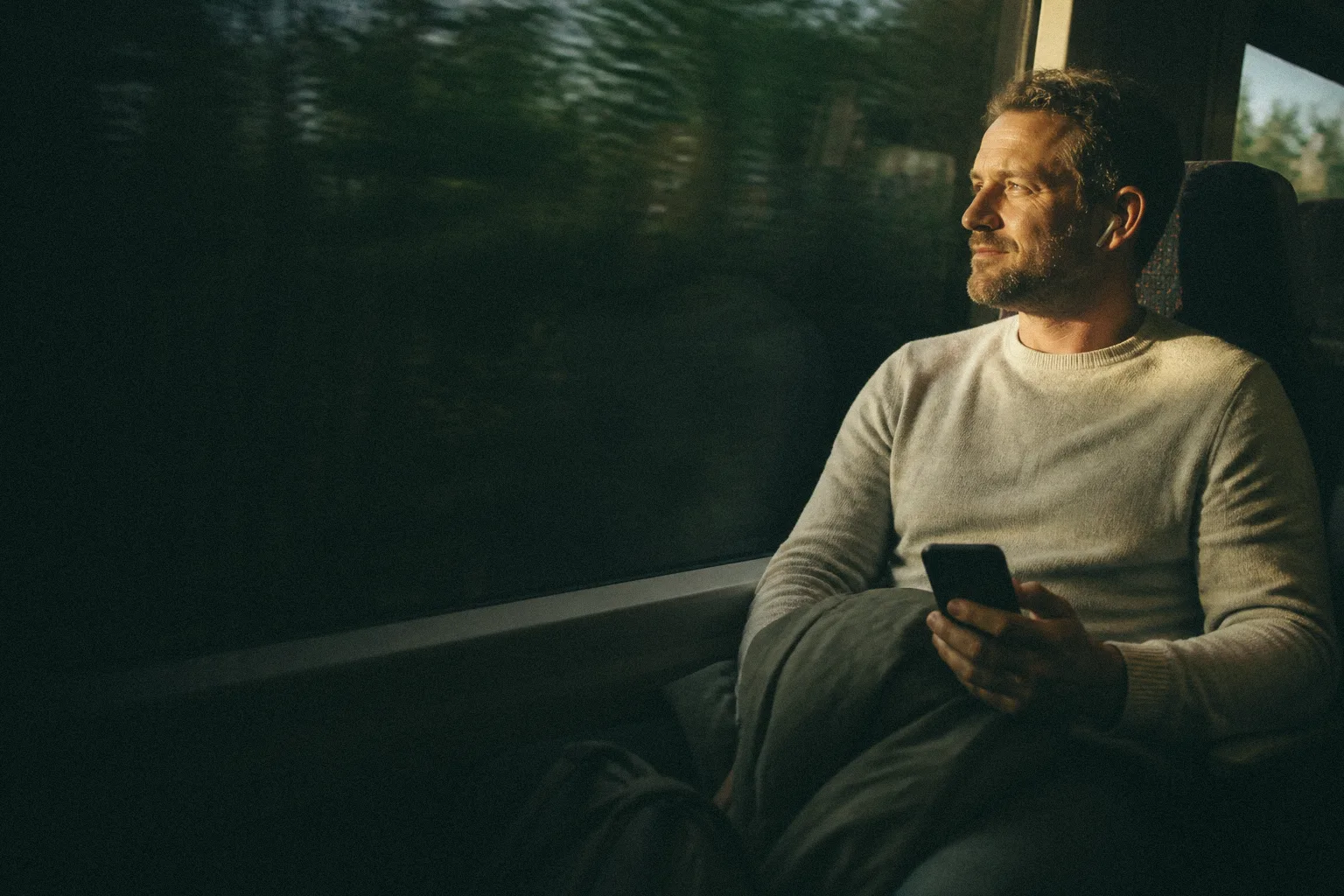 A Nerva member using his phone on a train